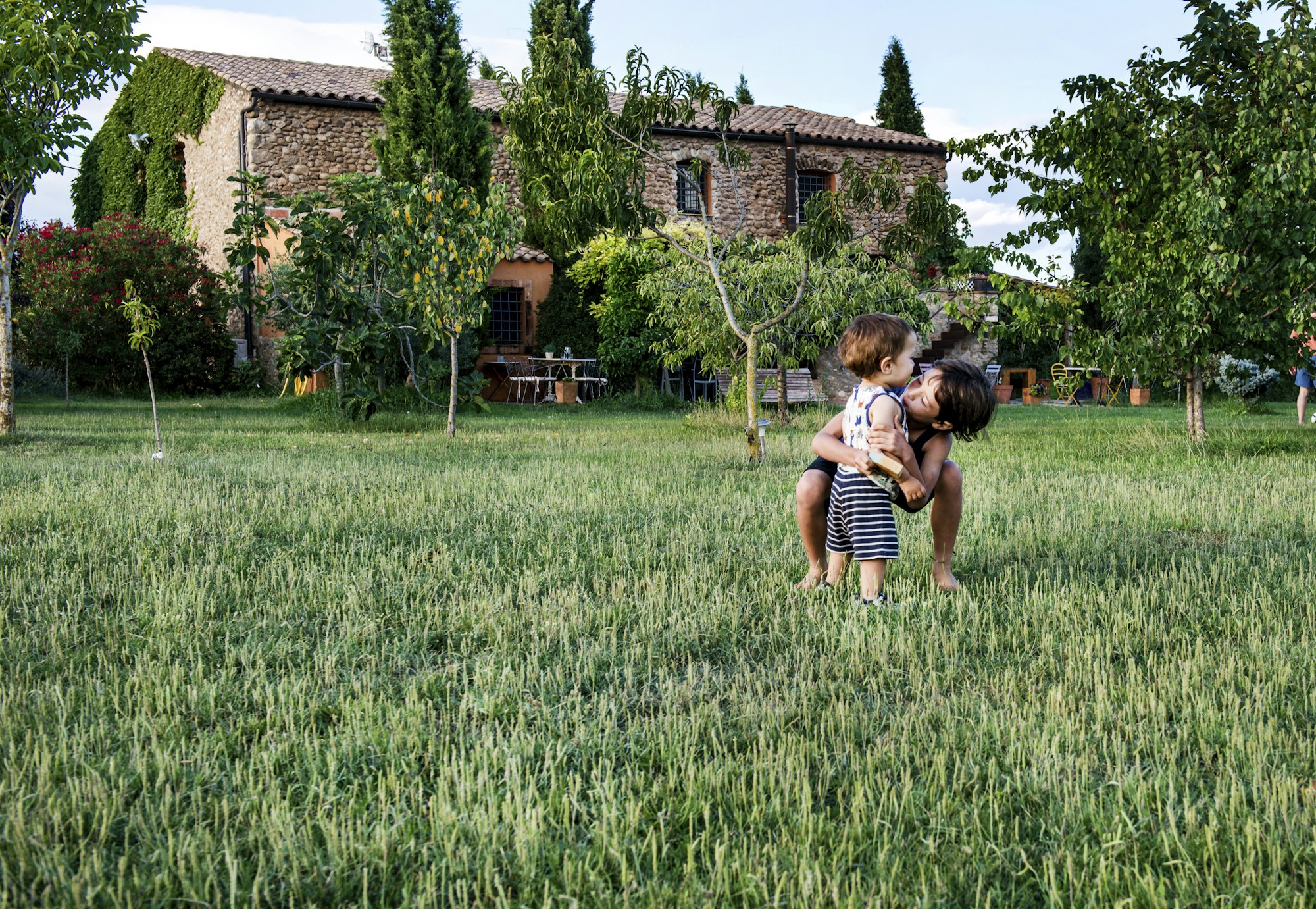 Kinder spielen im Garten einer traditionellen Finca auf Mallorca